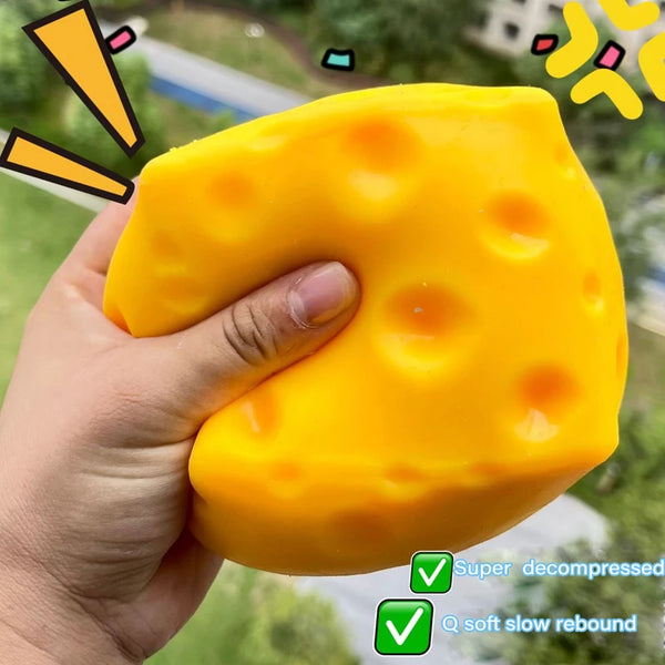 A hand holds a yellow cheese-shaped ornament demonstrating soft slow rebound and super decompressed quality.
