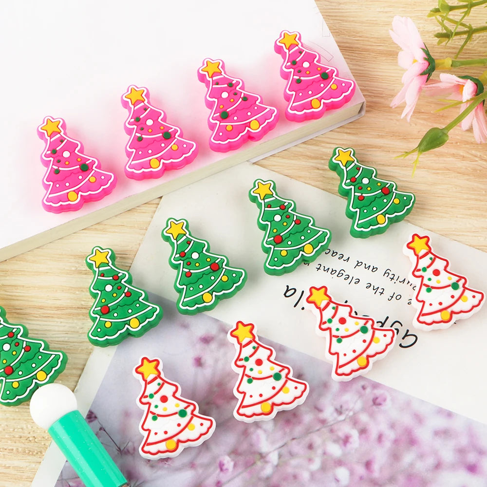 Pink and green Christmas tree silicone beads for jewelry making and DIY crafts displayed on a wooden surface.