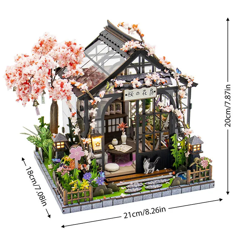 A detailed miniature dollhouse kit featuring a wooden structure, floral accents, and warm lighting.