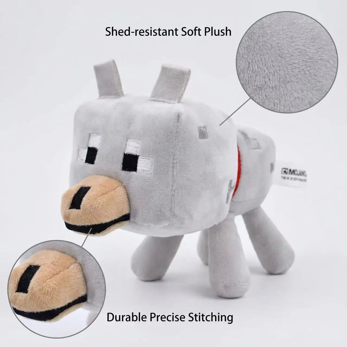 A gray plush toy resembling a wolf head with a tan muzzle, showing durable precise stitching details.