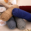 A collection of three skeins of soft cotton blend yarn in shades of beige, blue, and gray for knitting and crochet.