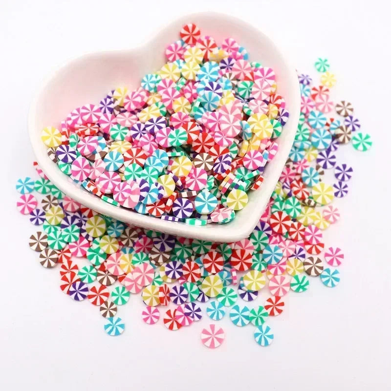 A pink bowl filled with colorful polymer clay sprinkles for slime and craft decor