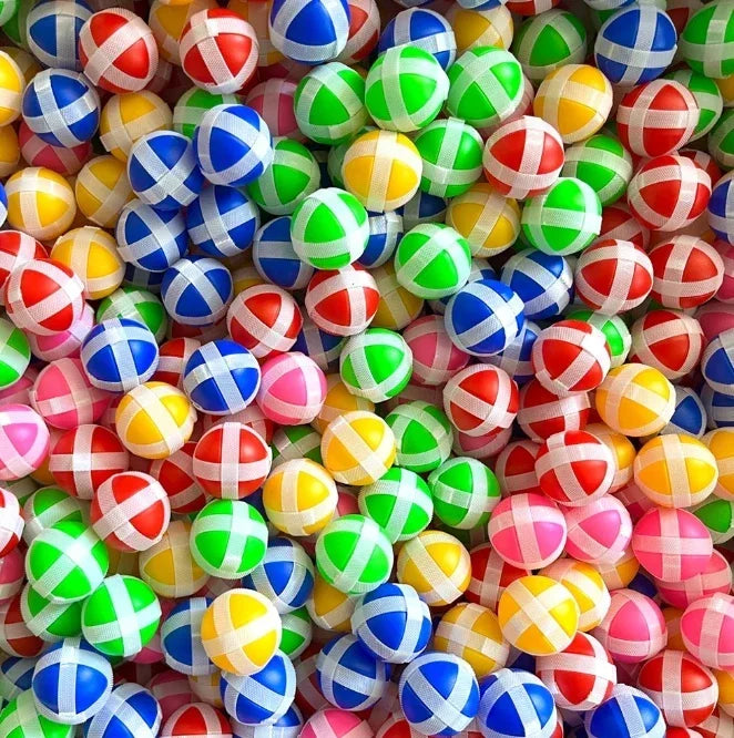 A pile of colorful sticky ball targets used for a shooting game set.