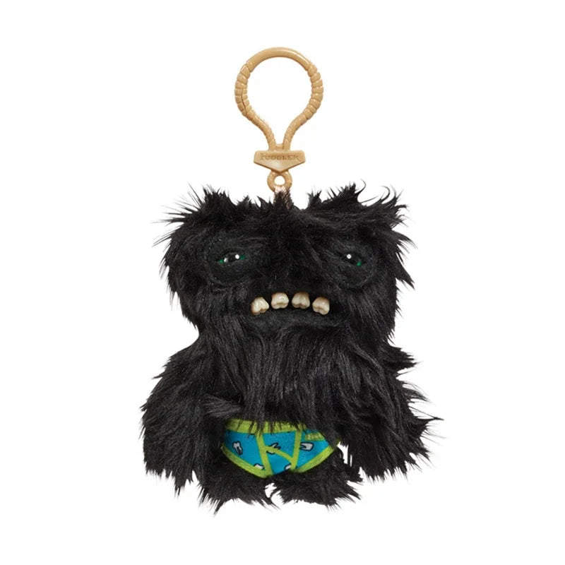 A black, furry monster plush with a goat-like face and a bone keychain attached to a leather loop.