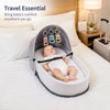 A portable foldable baby bed with a mosquito net and mattress is shown on a white bed.