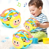 A baby is holding a yellow and blue sensory catch ball rattle toy designed for infants.