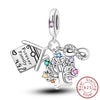 A sterling silver heart charm with a pendant engraved Forever Family.
