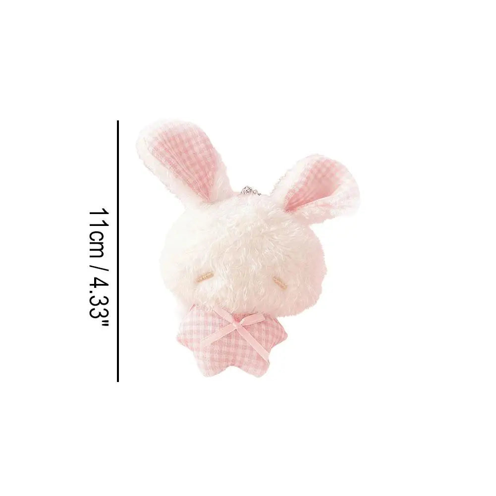 A pink plush bunny keychain with pink checkered ears and a pink bow.