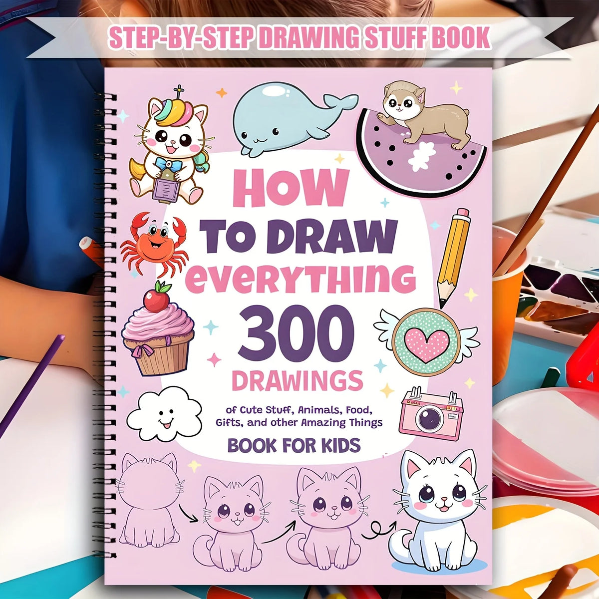 A pink spiral notebook titled How to Draw Everything 300 Drawings of Cute Stuff for Kids featuring various animal and object 