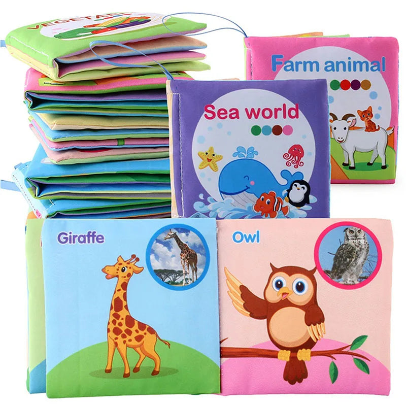 A collection of soft fabric baby books featuring animals like a giraffe, owl, and sea creatures.