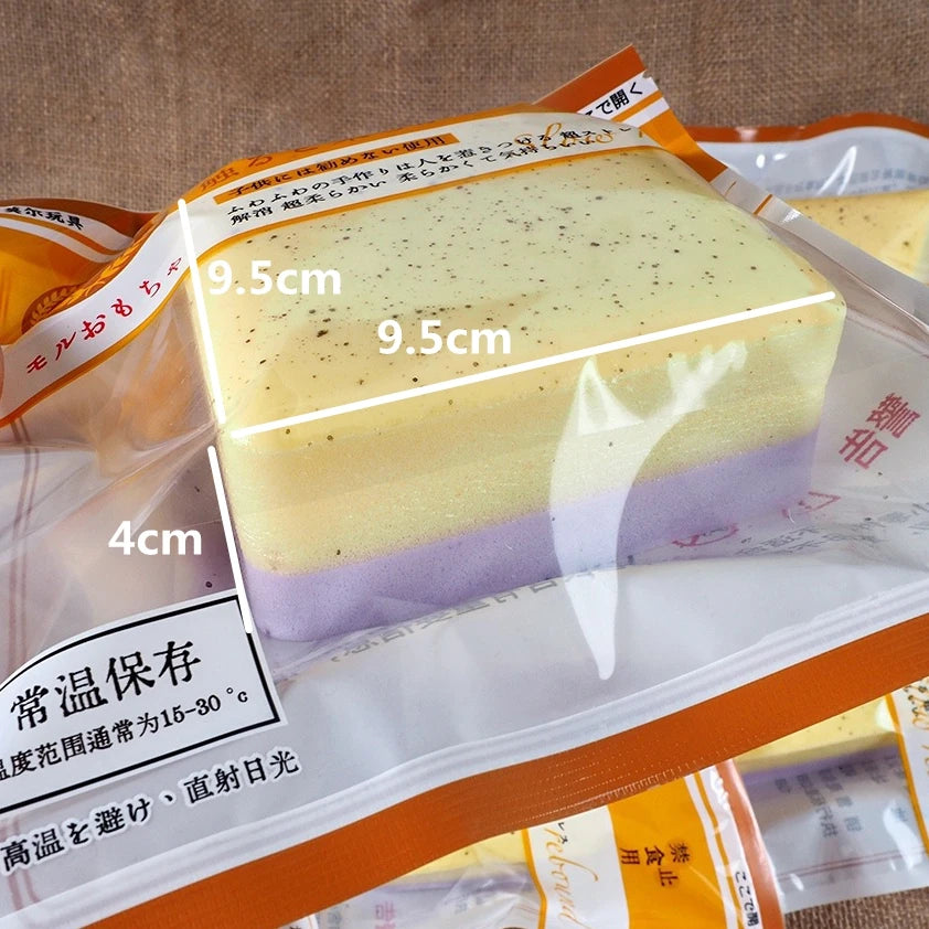 A block of yellow and purple squishy stress relief toy with measurement markings.