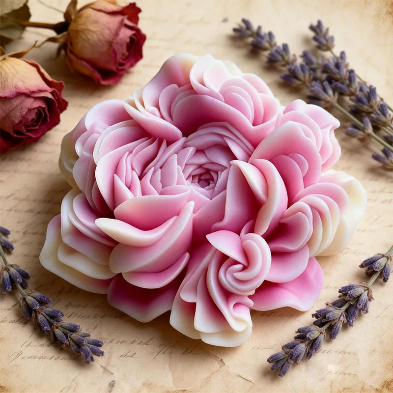 A pink floral silicone candle and resin mold surrounded by dried lavender sprigs on aged paper.