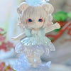 A cute figurine of a girl with light pink hair and blue eyes wearing a light blue dress and a butterfly accessory.
