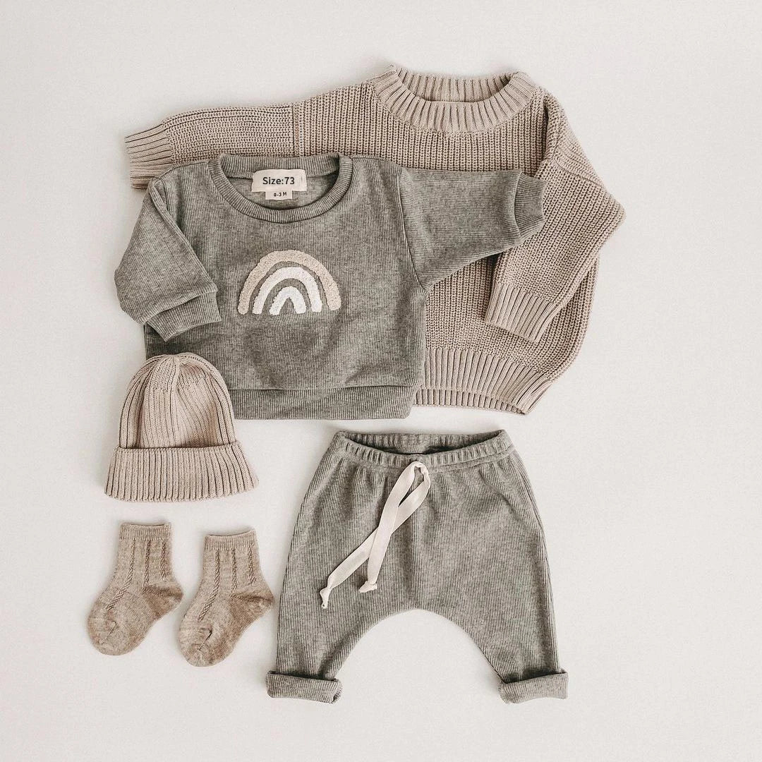 A gray knit outfit set for a baby girl featuring a long-sleeve top and matching pants.