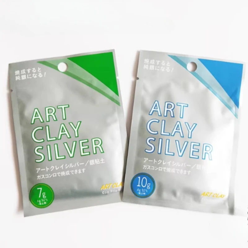 Two silver bags of art clay are shown, packaged for crafting jewelry.