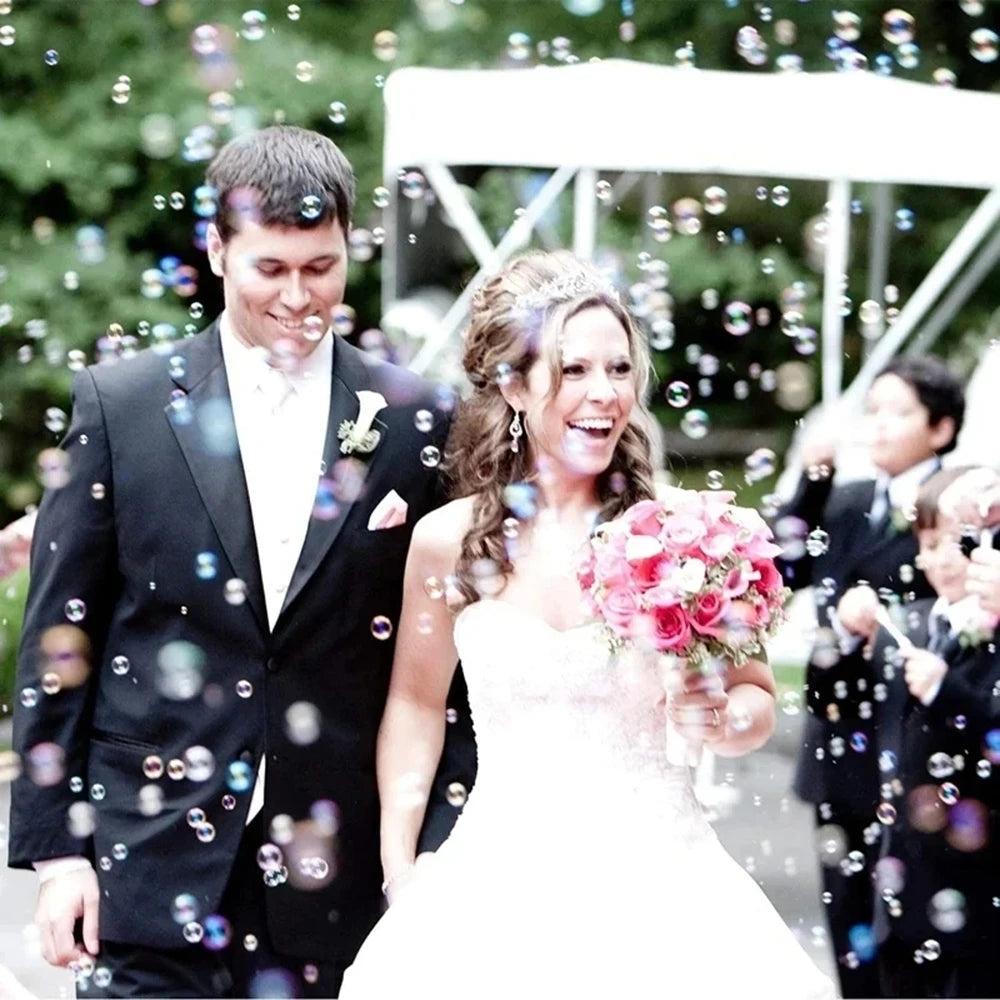 A bride and groom walk through sparkling bubbles during their celebration.