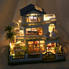 A detailed diorama of a wooden mini seaside villa dollhouse kit featuring furniture and decorative elements.