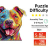 A colorful wooden dog jigsaw puzzle showing a happy dog face with bright paint and various colors.