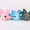 A set of three soft plush axolotl toys in pink, blue, and gray colors.