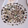 Assorted metal pendants and charms for jewelry making arranged on a light surface.