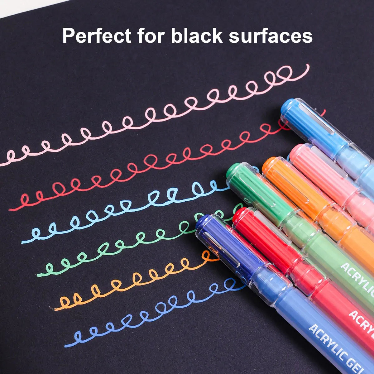 A set of six vibrant acrylic gel pens in various colors are shown writing on a black surface.