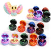 A set of six colorful 3D dragon egg surprise figurines in various shades of pink, purple, green, and orange.