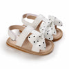 Pair of white baby first walker sandals with soft anti-slip soles and decorative ear accents