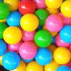 A close-up view of a large assortment of brightly colored plastic play balls in various shades of yellow, green, pink, and bl
