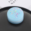 A light blue squishy stress relief toy with colorful confetti on a dark plate.