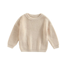 A beige knit pullover sweater for kids with a round neckline and long sleeves.
