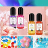 A set of 24 color resin pigments including Violet, Pink, Yellow, and Orange in glass bottles displayed against a pink backgro