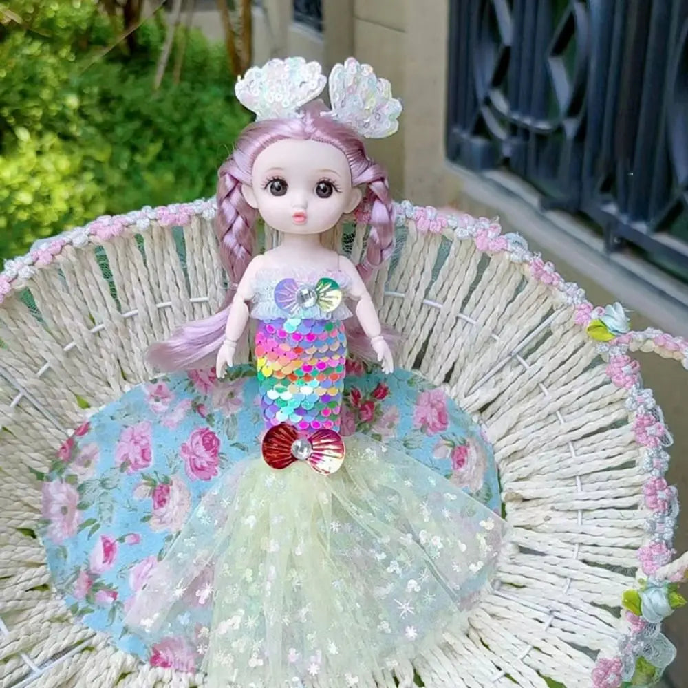 A mermaid doll with pink hair and a sequin dress sitting in a woven basket.