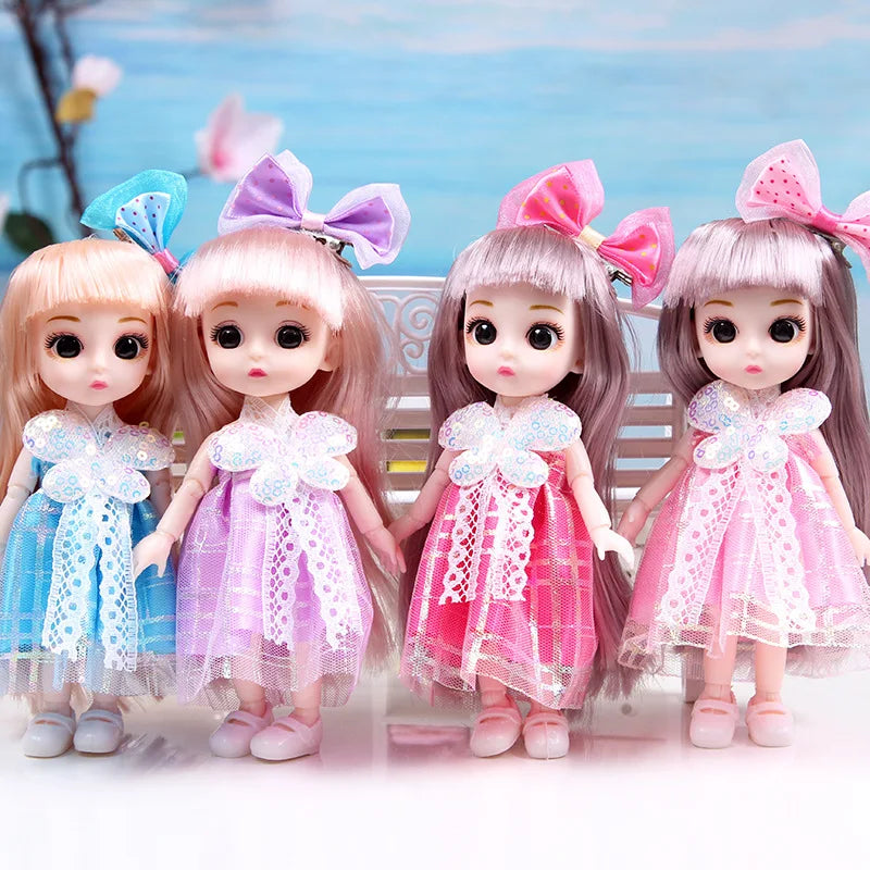 A set of four 17cm articulated princess dolls with dresses and bows in shades of pink and purple.