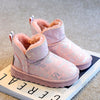 Pink fur-lined winter snow boots with a non-slip sole resting on a white surface.