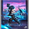 A collectible PVC figurine of Hanzo from Overwatch, featuring dark clothing and a glowing blue sword against a purple sunset 