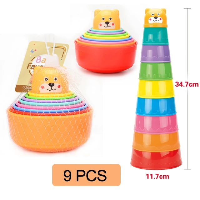 A set of nine colorful boat-shaped stacking cups for toddlers, including a main container and a tower.