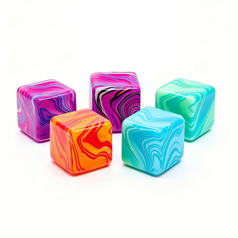Four colorful, marbled cube toys in pink, purple, orange, and teal are displayed on a white background.