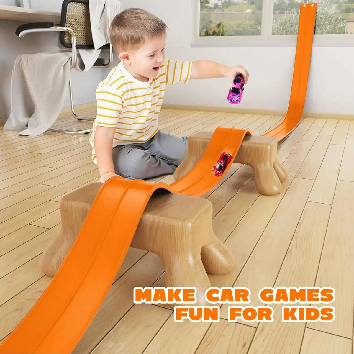 An orange flexible car race track is set up on a wooden block for kids to play.