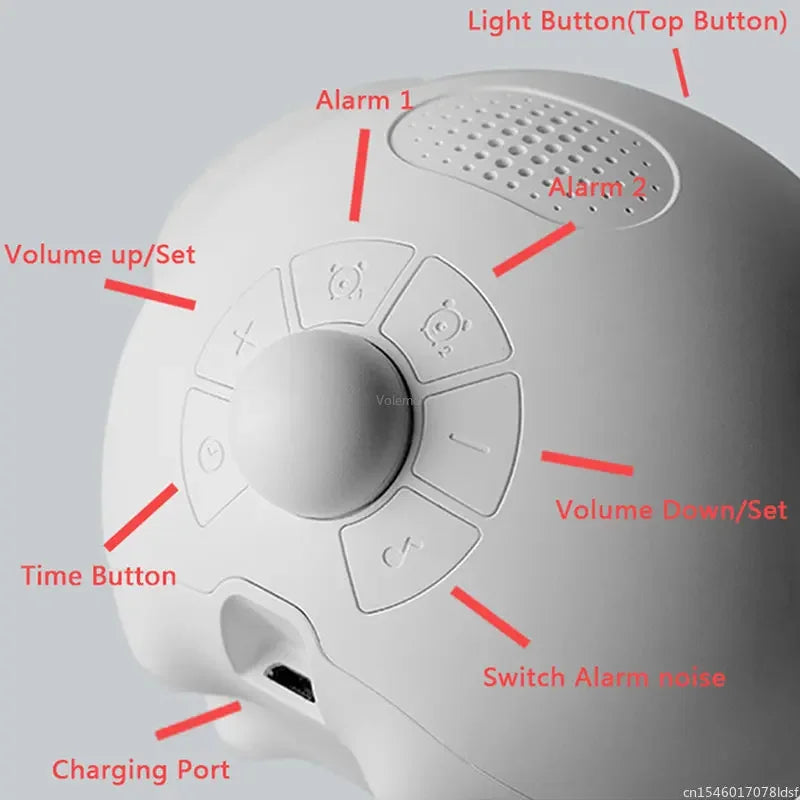 A white emoji alarm clock with various buttons including light buttons, volume controls, a time button, and a charging port.