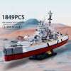 A 1:350 scale model kit of a Bismarck Battleship built from plastic blocks, featuring gray and red colors.