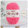 A ball of bright pink chenille yarn labeled with Chinese characters for knitting and crochet.