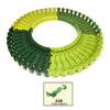 A circular track set made of interlocking plastic pieces in green and yellow colors.