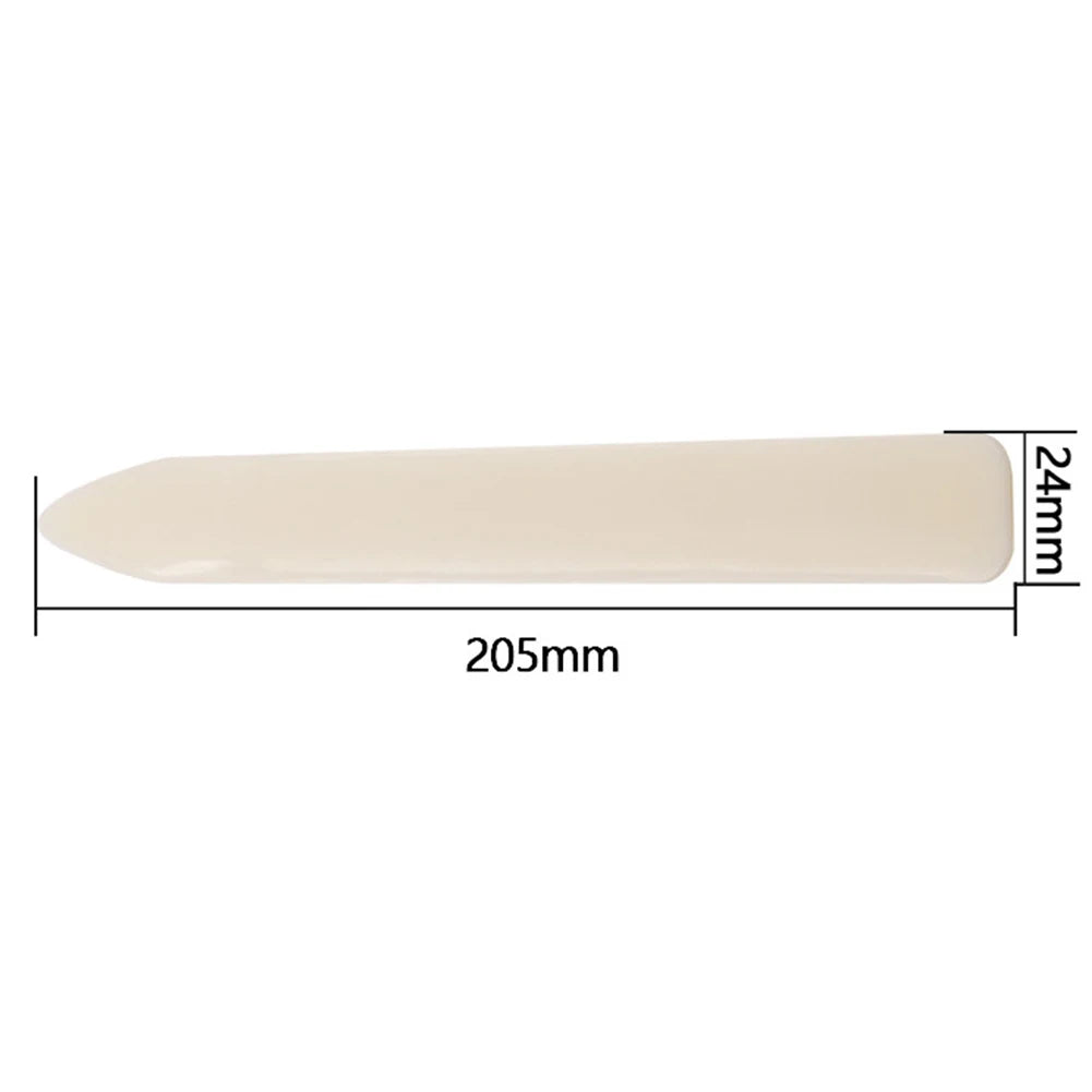 A rectangular, light beige plastic bone folder with dimensions 205mm long and 24mm high.
