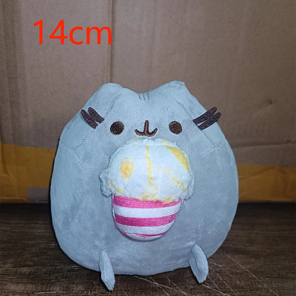 A light blue plush cat doll with pink and white striped accents, shown against a brown background.