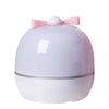 A white projector night light with a pink bow on top, featuring rotating galaxy effects.
