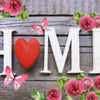 Diamond painting kit featuring a heart and floral design with pink and red roses on a wooden background.