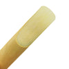 A close-up view of a light wood saxophone and clarinet reed.