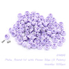A pile of lavender round plates with a flower edge for building blocks.