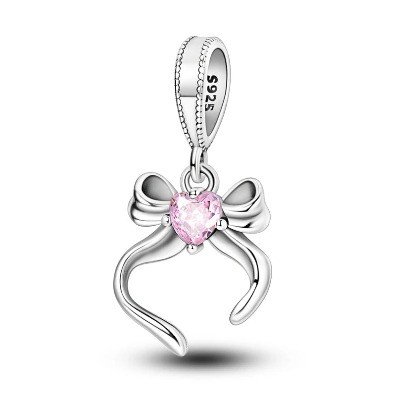 A sterling silver heart charm bead featuring a pink zircon gemstone.