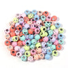 A collection of colorful rhinestone acrylic spacer beads in various shades of pink, green, yellow, and blue.